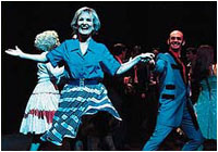 Lyn Paul as Mrs. Johnstone, dancing with the Blood Brothers cast (Act 1).