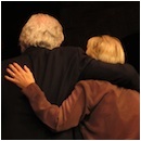 Bill Kenwright and Lyn Paul leave the stage with their arms around each other.